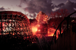 Wicker man at Alton Towers at night with flames surrounding track