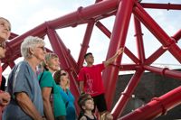 Crowd of people being shown arcelormittal orbit by guide