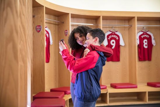 Mum and son on the stadium tour in the Arsenal changing rooms