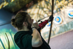 Man holding bow and arrow at Bear Grylls Adventure archery