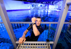 Bear Grylls coming out of swimming pool at Bear Grylls Adventure Shark Dive
