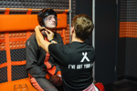 Man gets helmet fitted before indoor sky diving at The Bear Grylls Adventure I Fly