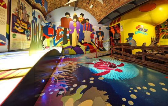 Funky, hippie-style room in Beatles Story Liverpool with underwater theme and murals of Beatles band members