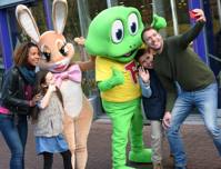 Family taking selfies with Cadbury world characters Freddo and Caramel Rabbit
