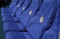 Close up view of seats at Chelsea FC Stadium, seats have blue covers with Chelsea Logo embroidered on
