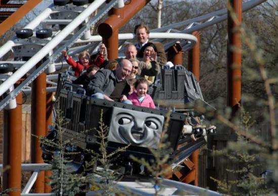 Family on a kids rollercoaster with Thomas the Tank Engine character