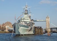 HMS Belfast on River Thames on sunny day with Tower Bridge in background