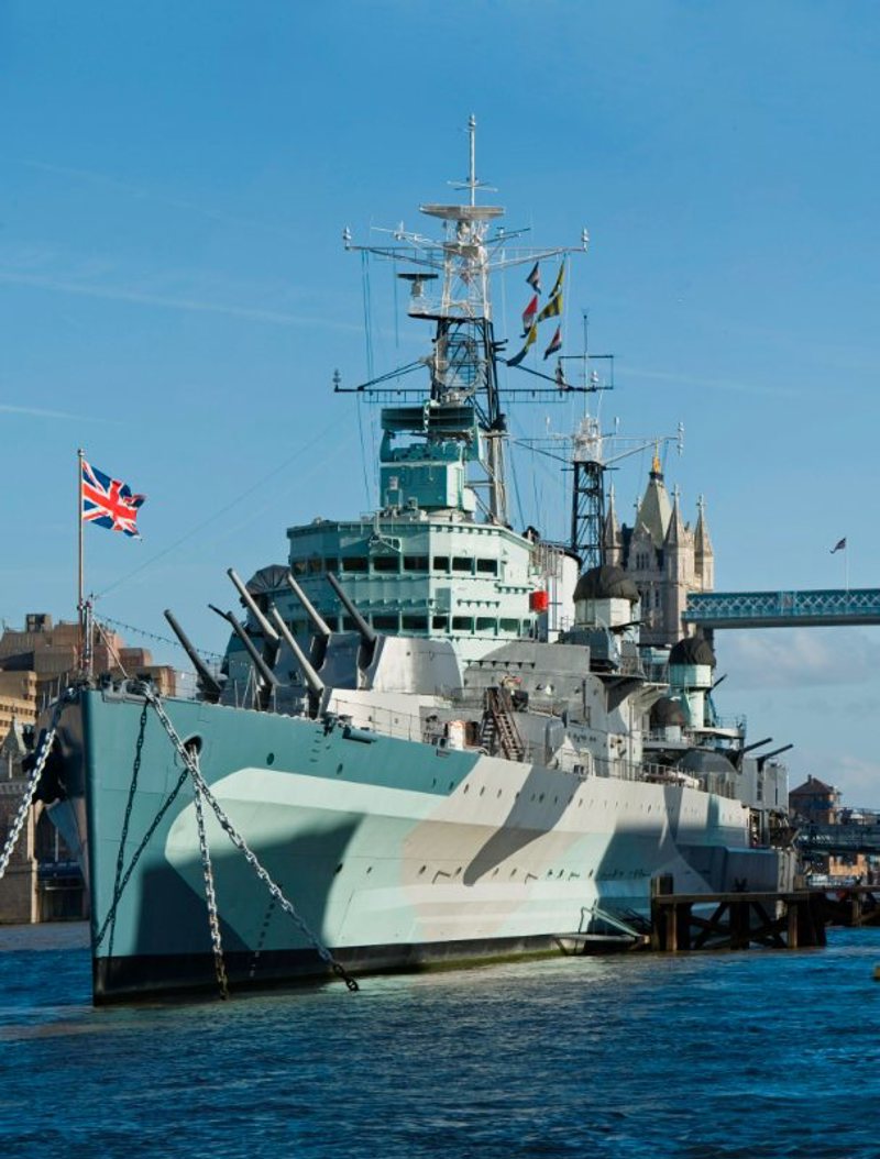 Portrait angle view of HMS Belfast front with Union Jack visible