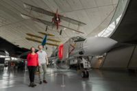 Couple exploring the displays at the Imperial War Museum Duxford