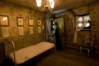 Bedroom with ghostly figure in doorway at the Jack the ripper museum