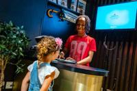 Children acting as Conceirge and hotel guest at KidZania London