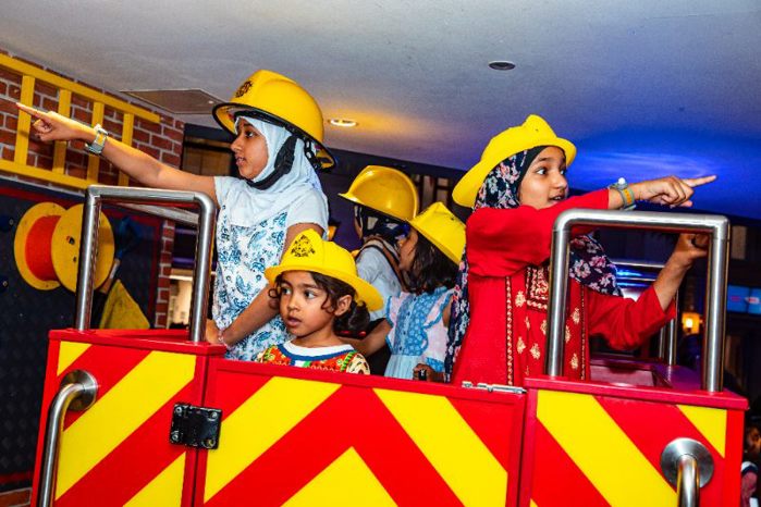 Children acting as Fire Fighters in Fire Engine at KidZania London