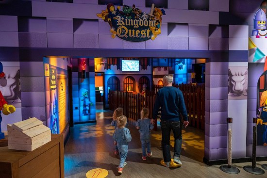 Family walking through entrance of Kingdom Quest at Legoland Discovery Centre Birmingham
