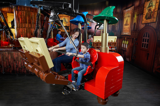 Child and parent enjoying Merlin's Apprentice ride Lego Discovery Centre Birmingham