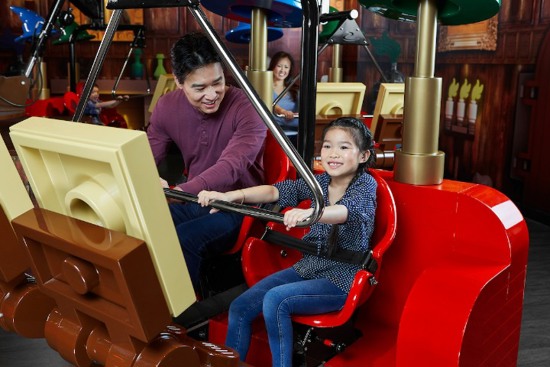 Child and Parent enjoying Merlin's Apprentice ride at Legoland Manchester