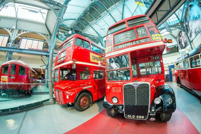 Old red double decker buses displayed in museum