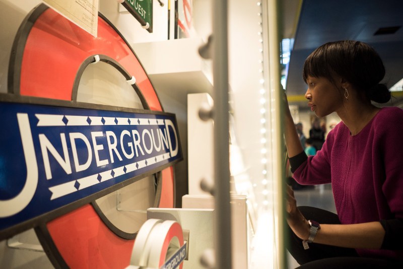 Woman looking at display in museum on London Underground