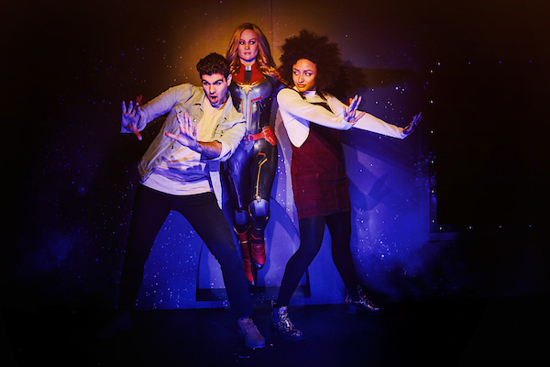 Couple pose with Captain Marvel wax work at Marvel Universe 4D at Madame Tussauds London