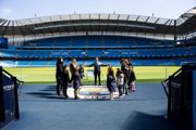 View of Manchester City Etihad stadium with some people sat in seats