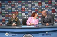 Family visiting Manchester City Stadium Tour sat with Pep Guardiola