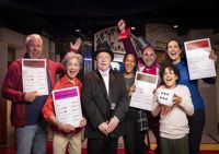 group of people holding certificates at Monopoly Lifesized