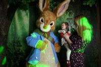 Young child enjoys meeting Peter Rabbit