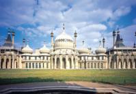 Royal Pavilion Brighton from a low angle on a sunny day with grass and path in front of building