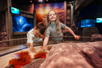 Two children touch a Sea Anemone at Rock Pool Explorer Great Yarmouth