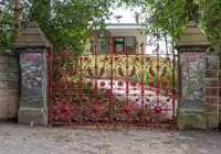 Entrance gate to Strawberry Field Liverpool painted red 