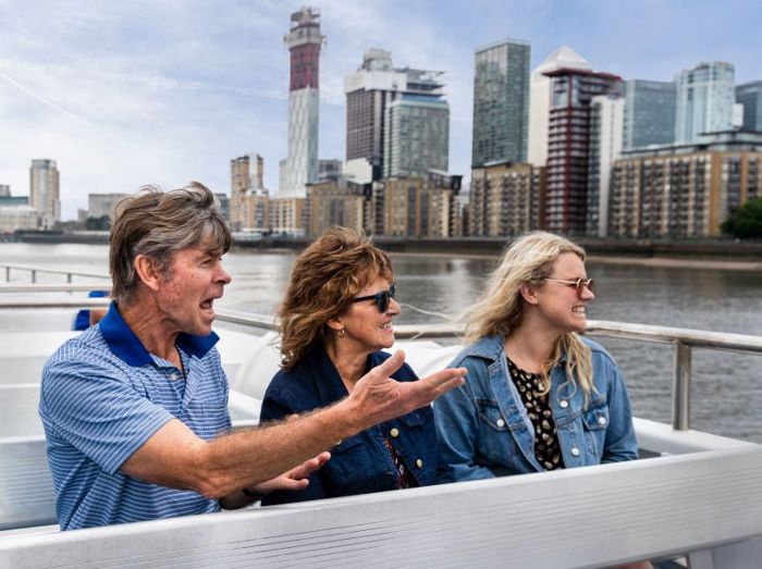 Three people sat on Thames River Sightseeing boat