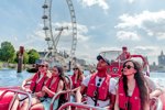 Group of people enjoying boat ride in front of London Eye