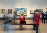 Woman sat looking at painting in The National Gallery