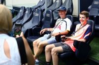 People sat in pitch-side seats at Tottenham Hotspur Stadium Tour
