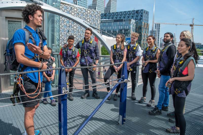 People wearing harnesses getting safety briefing at Up at The O2