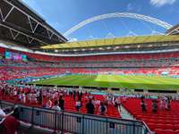 Rows of people at seats inside Wembley Stadium