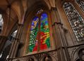 Detailed glass window with red, green, blue and yellow panes of glass - designed by David Hockney for Westminster Abbey